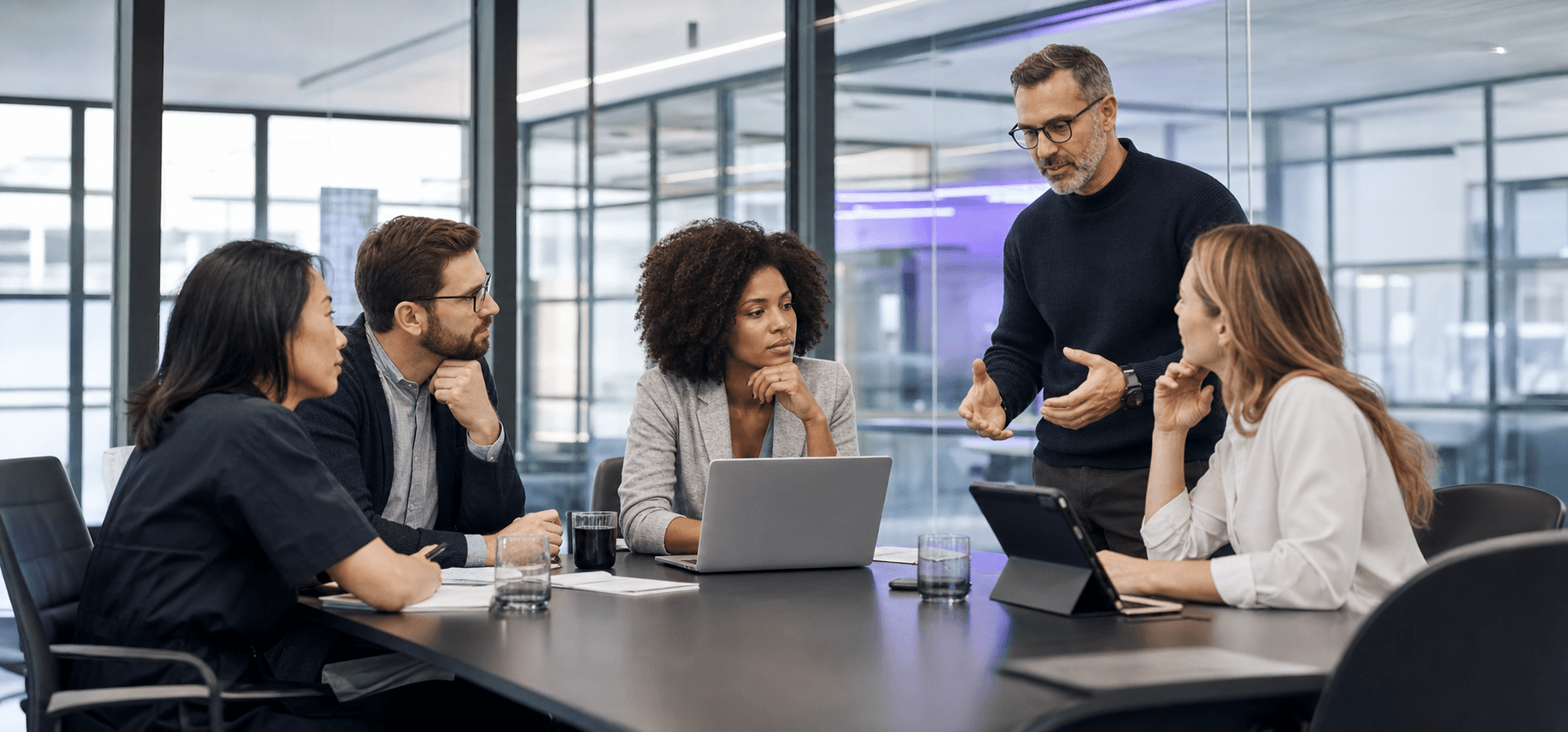 Professional enterprise team discussing a project in a modern meeting room